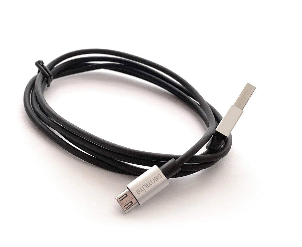 A black DermLite USB-Micro Charging Cable (DL4/DL200/DL1/Lumio S) connected to a white surface.