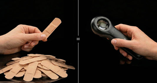 A band-aid being held in one hand while a Dermlite DL5 is held in the other, to emphasize how, over time, they both cost the same in our practice.